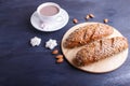 Rye bread with sunflower seeds, sesame and flax with cup of cocoa on dark blue background Royalty Free Stock Photo