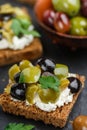 Rye bread toast canape with kalamata, black and green olives, feta chees