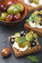 Rye bread toast canape with kalamata, black and green olives, feta chees