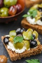 Rye bread toast canape with kalamata, black and green olives, feta chees