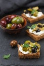 Rye bread toast canape with kalamata, black and green olives, feta chees