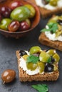 Rye bread toast canape with kalamata, black and green olives, feta chees