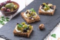 Rye bread toast canape with kalamata, black and green olives, feta chees