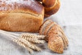 Rye bread, wheat loaf with poppy seeds and ears on sacking Royalty Free Stock Photo