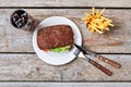Rye bun burger and cutlery. Royalty Free Stock Photo