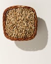 Rye cereal grain. Wicker basket with grains. Top view, hard light.