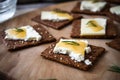 rye cracker halves with a smear of cheese spread on them Royalty Free Stock Photo