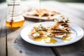rye crackers with goat cheese, honey drizzle, wooden table Royalty Free Stock Photo