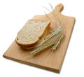 Rye ears (spikes) and loafs of bread on wooden board