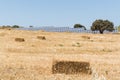 Rye field with bales of hay and solar energy batteries in Milos island, Greece Royalty Free Stock Photo