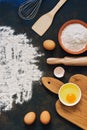 Rye flour, rolling pin, whisk, paddle, eggs, cutting board.Ingredients for baking rye bread. View from above. Place for text. Royalty Free Stock Photo