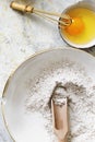 Rye flour with a wooden scoop next to a bowl of fresh egg flatlay Royalty Free Stock Photo