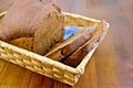 Rye homemade bread in a wicker basket on the board Royalty Free Stock Photo