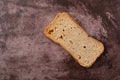 Rye melba toast slice on a maroon background
