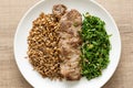 Rye, steak and cabbage meal on white plate. Overhead, flat lay o Royalty Free Stock Photo