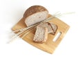 Rye and wheat bread. A loaf of bread on a cutting board with ears of wheat. Food. Top view Royalty Free Stock Photo