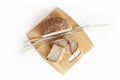 Rye and wheat bread. A loaf of bread on a cutting board with ears of wheat. Food. Top view Royalty Free Stock Photo