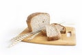 Rye and wheat bread. A loaf of bread on a cutting board with ears of wheat and a handful of wheat flour. Food Royalty Free Stock Photo