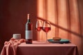 ?rystal glasses and bottle with pink wine stand on the table. Sunlight and shadows accentuates the airiness and refinement.