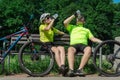 Rzeszow, Poland - Jun 23.2019 A young guy and a young girl are resting after a bike ride, drinking water, sitting on a bench. Royalty Free Stock Photo