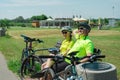 Rzeszow, Poland - Jun 23.2019 A young guy and a young girl are resting after a bike ride, drinking water, sitting on a bench. Royalty Free Stock Photo