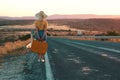 20s age One woman with a straw hat hitchhiking by the country roadside Royalty Free Stock Photo