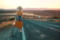 20s age One woman with a straw hat hitchhiking by the country roadside Royalty Free Stock Photo