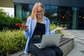 Frustrated business woman received bad news in e-mail on mobile phone while sits outside company near copy space Royalty Free Stock Photo