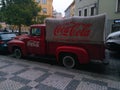 Company old truck with Coca-Cola logo parked on a street in the center of Prag