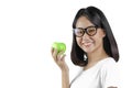 20s an Asian young woman holding a green apple with the white background