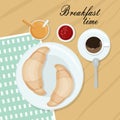 It`s breakfast time. Two freshly baked croissants on a plate, a mug of black coffee, orange juice and strawberry wait. On a wooden