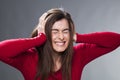 30's brunette getting mad, suffering from headache, covering her ears with her hands Royalty Free Stock Photo
