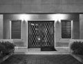 A 60s classic residential apartment building entrance in retro black and white night capture.