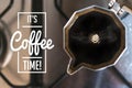 It`s coffee time concept: a moka pot full of fresh coffee on the kitchen stove