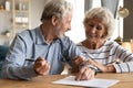 70s couple discuss agreement ready to sign contract Royalty Free Stock Photo