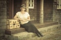 1920s Dressed Girl and Suitcases on Porch with Vintage Effect