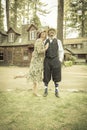 1920s Dressed Romantic Couple in Front of Old Cabin