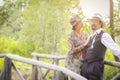 1920s Dressed Romantic Couple on Wooden Bridge