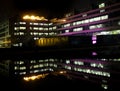 The 1960s E C Stoner building in Leeds University in West Yorkshire England reflected in the pond at night