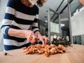 70 s elegant old senior lady working manually with sick wrinkled hands curing dried roses for home decoration hobby Royalty Free Stock Photo