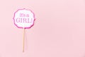 It`s a girl sign at the baby shower party. Pink solid background. Baby shower celebration concept