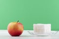 It s hard to choose healthy food concept, with woman hand holding an green apple and a calorie bomb donut Royalty Free Stock Photo