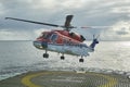 An S92 helicopter from CHC Helicopter Services landing on a Seismic Vessel during a Snow Flurry. Royalty Free Stock Photo