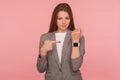 It`s late, hurry up! Portrait of impatient worried busy lady in business suit pointing to watch on her wrist