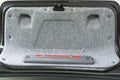 2000`s luxury black car trunk lid with warning triangle installed