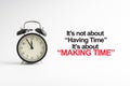 IT`S NOT ABOUT HAVING TIME IT`S ABOUT MAKING TIME inscription written and alarm clock on white background Royalty Free Stock Photo