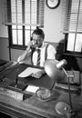 1950s office: director on the phone Royalty Free Stock Photo