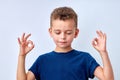 it's OK. calm child boy showing ok gesture, isolated on white studio background.