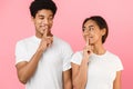 It`s our secret. Teens holding fingers on lips and looking at each other Royalty Free Stock Photo