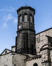 A black clock tower of a medieval church Royalty Free Stock Photo